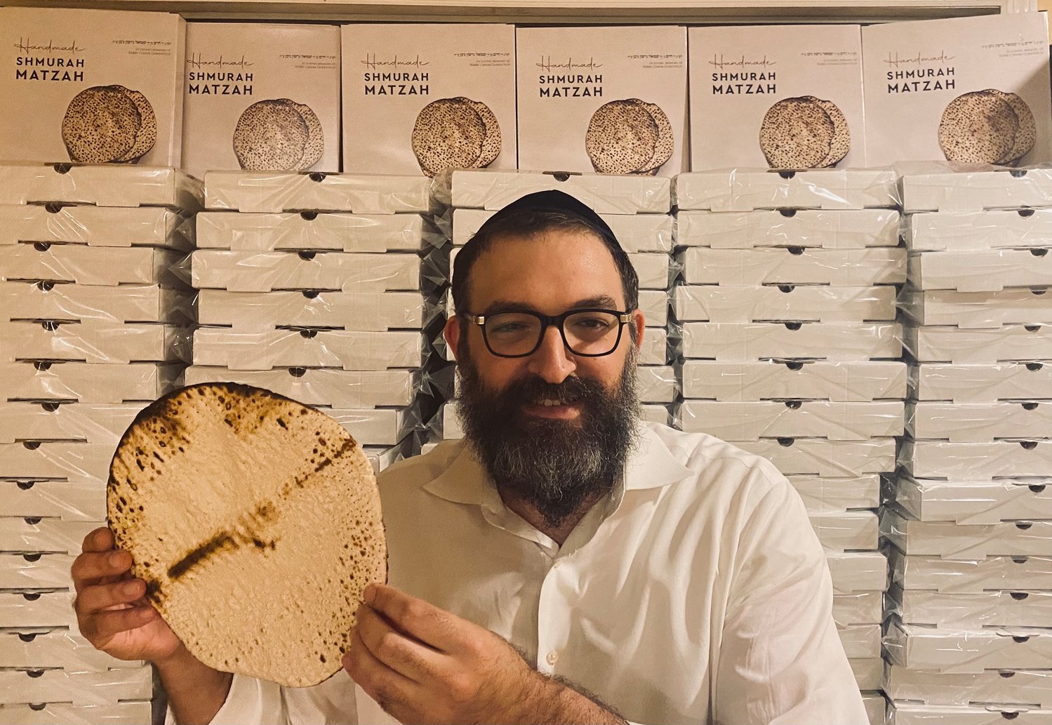 Rabbi Shimon Stillerman of the Chabad of Islip Township holds matzah from Ukraine that will be distributed to homes in the Islip area.